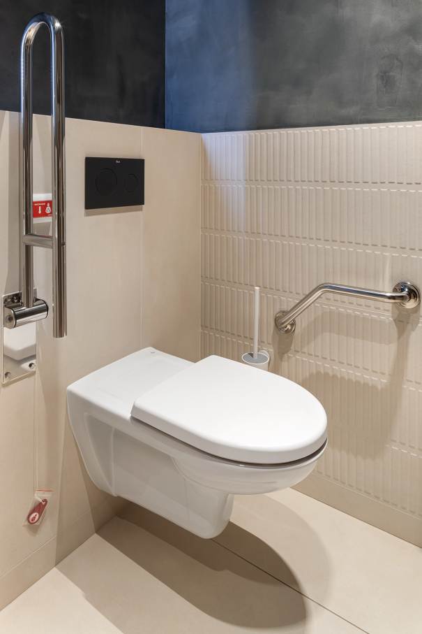 La prioridad en el diseño interior del hotel es garantizar que los huéspedes se vayan con una sonrisa, sintiéndose relajados y completamente satisfechos. Adoptando el enfoque minimalista del hygge, el diseño transmite una agradable sensación de confort a través de una cuidada selección de colores y mobiliario en materiales naturales con suaves curvas y formas orgánicas. En perfecta sintonía con la filosofía hygge, las líneas suaves y las formas redondeadas del lavabo Beyond de color café y del inodoro y bidé Inspira irradian relajación, calidez y armonía. El diseño de la colección Ona, inspirado en la naturaleza, se suma a la estética relajante. Los bidés y lavabos suspendidos contribuyen a crear una sensación de amplitud y equilibrio que evoca la serenidad de los paisajes tranquilos. De esta forma, el confort y el hygge se transmiten a todos los huéspedes del hotel. Los aseos públicos para hombres cuentan con los minimalistas urinarios Proton y los aseos accesibles están equipados con inodoros Access y asas de baño, garantizando un entorno acogedor e inclusivo para todos.3