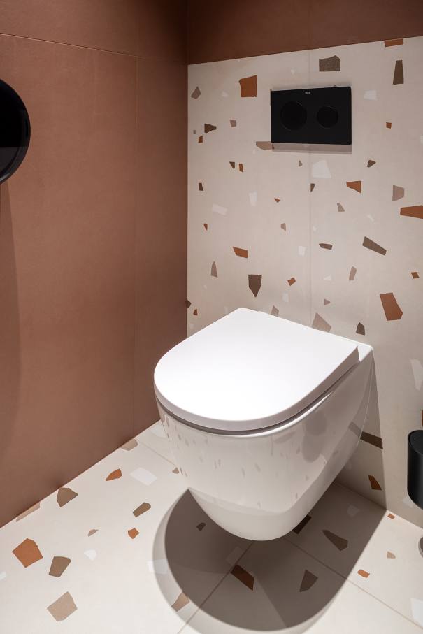 La prioridad en el diseño interior del hotel es garantizar que los huéspedes se vayan con una sonrisa, sintiéndose relajados y completamente satisfechos. Adoptando el enfoque minimalista del hygge, el diseño transmite una agradable sensación de confort a través de una cuidada selección de colores y mobiliario en materiales naturales con suaves curvas y formas orgánicas. En perfecta sintonía con la filosofía hygge, las líneas suaves y las formas redondeadas del lavabo Beyond de color café y del inodoro y bidé Inspira irradian relajación, calidez y armonía. El diseño de la colección Ona, inspirado en la naturaleza, se suma a la estética relajante. Los bidés y lavabos suspendidos contribuyen a crear una sensación de amplitud y equilibrio que evoca la serenidad de los paisajes tranquilos. De esta forma, el confort y el hygge se transmiten a todos los huéspedes del hotel. Los aseos públicos para hombres cuentan con los minimalistas urinarios Proton y los aseos accesibles están equipados con inodoros Access y asas de baño, garantizando un entorno acogedor e inclusivo para todos.33