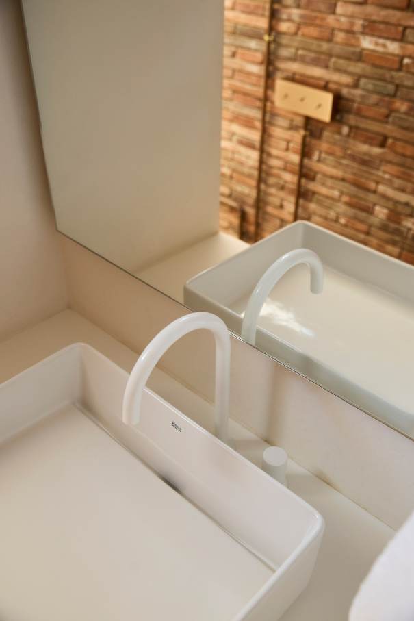 La distribución de Casa IV transforma el baño en un elemento fluido del espacio vital, contribuyendo a mejorar la experiencia de los habitantes de la vivienda. La incorporación de la bañera, el inodoro y el lavabo sobre encimera de la colección Tura genera una sensación de calma y sofisticación, mientras que la grifería Stripes de la colección Nu introduce un toque de dinamismo. La bañera trasciende lo funcional, convirtiéndose en el centro de atención del dormitorio y en un símbolo del estilo de vida mediterráneo. Esta vivienda es un ejemplo de cómo los productos Roca mejoran la experiencia de los usuarios, creando una mezcla perfecta de funcionalidad y diseño, en línea con la filosofía del proyecto, basada en la elegancia discreta y en los detalles cuidadosamente escogidos.21