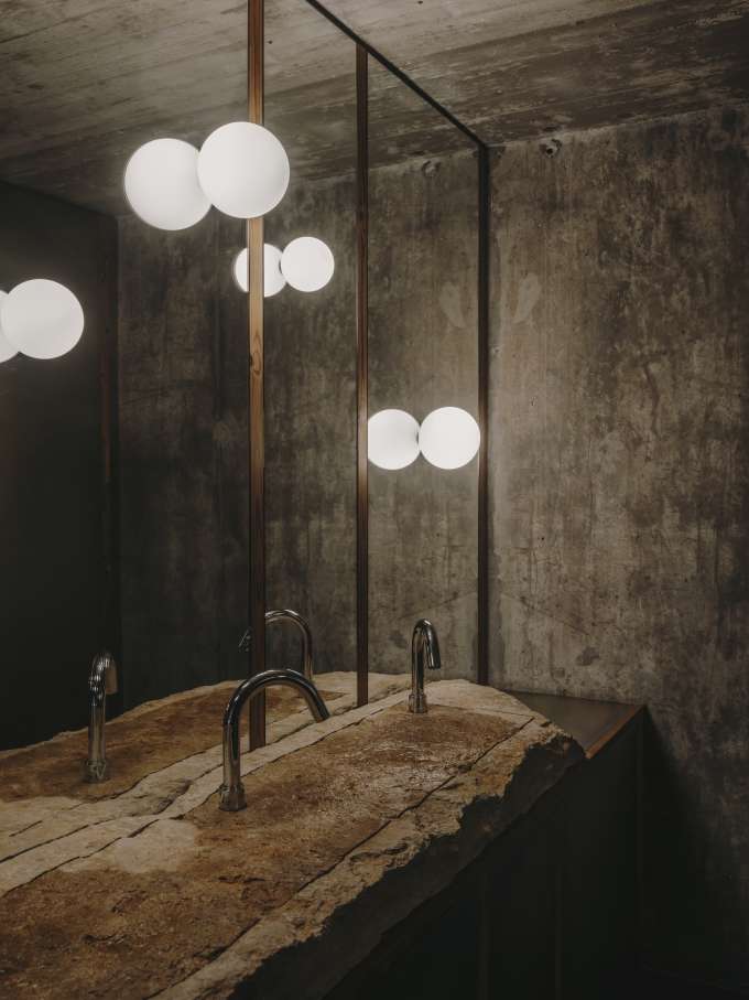 El diseño de Carulla para el restaurante, también denominado Esperit Roca, combina suaves tonos tierra con paredes de hormigón, detalles en piedra y una cálida iluminación para crear un espacio acogedor que transmite una sutil sofisticación. En los espacios de baño se ha optado por el inodoro suspendido Roca Rimless® de la colección Tura, concebida por el diseñador, para lograr una estética unificada. Al igual que el propio restaurante, el diseño escultural del inodoro está inspirado en el paisaje mediterráneo de la región. Otros elementos seleccionados incluyen la grifería electrónica Loft, que se integra a la perfección en los lavabos de piedra. La silueta casi industrial de la grifería complementa la solidez de la piedra y el espacio en penumbra, mientras que la tecnología electrónica aporta eficiencia hídrica y facilidad de uso.2